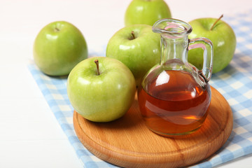 apples and apple cider vinegar on the table.