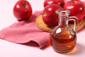 apples and apple cider vinegar on the table.
