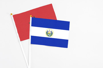 El Salvador and Morocco stick flags on white background. High quality fabric, miniature national flag. Peaceful global concept.White floor for copy space.