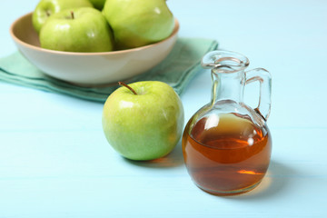 apples and apple cider vinegar on the table.
