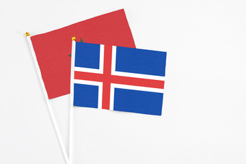 Obraz premium Iceland and Morocco stick flags on white background. High quality fabric, miniature national flag. Peaceful global concept.White floor for copy space.