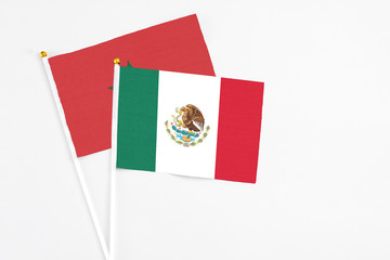 Mexico and Morocco stick flags on white background. High quality fabric, miniature national flag. Peaceful global concept.White floor for copy space.