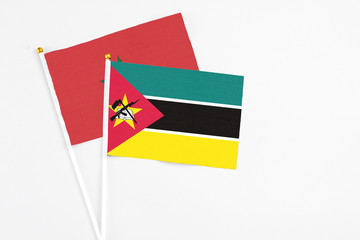Mozambique and Morocco stick flags on white background. High quality fabric, miniature national flag. Peaceful global concept.White floor for copy space.