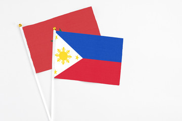 Philippines and Morocco stick flags on white background. High quality fabric, miniature national flag. Peaceful global concept.White floor for copy space.