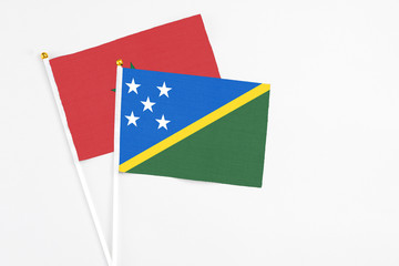 Solomon Islands and Morocco stick flags on white background. High quality fabric, miniature...