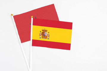 Spain and Morocco stick flags on white background. High quality fabric, miniature national flag. Peaceful global concept.White floor for copy space.