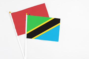 Tanzania and Morocco stick flags on white background. High quality fabric, miniature national flag. Peaceful global concept.White floor for copy space.