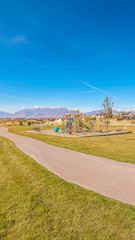 Fototapeta na wymiar Vertical Kids playground in a neatly landscaped park