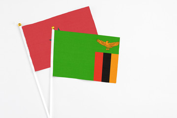 Zambia and Morocco stick flags on white background. High quality fabric, miniature national flag. Peaceful global concept.White floor for copy space.
