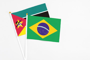 Brazil and Mozambique stick flags on white background. High quality fabric, miniature national...