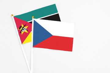 Czech Republic and Mozambique stick flags on white background. High quality fabric, miniature national flag. Peaceful global concept.White floor for copy space.