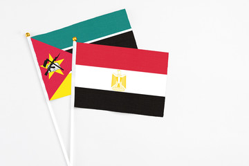Egypt and Mozambique stick flags on white background. High quality fabric, miniature national flag. Peaceful global concept.White floor for copy space.