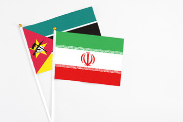 Iran and Mozambique stick flags on white background. High quality fabric, miniature national flag....
