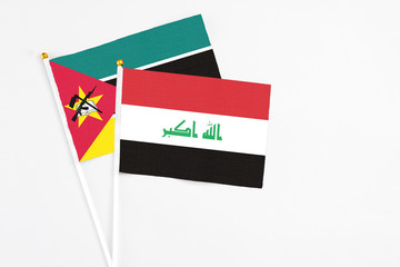 Iraq and Mozambique stick flags on white background. High quality fabric, miniature national flag. Peaceful global concept.White floor for copy space.
