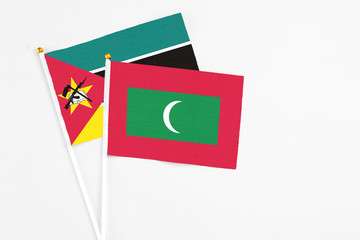 Maldives and Mozambique stick flags on white background. High quality fabric, miniature national...