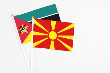 Macedonia and Mozambique stick flags on white background. High quality fabric, miniature national...