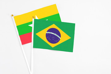 Brazil and Myanmar stick flags on white background. High quality fabric, miniature national flag. Peaceful global concept.White floor for copy space.