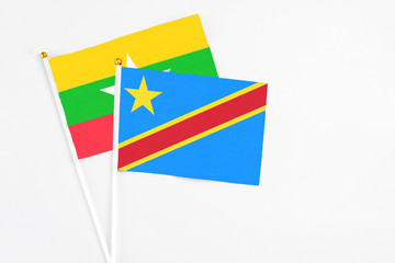 Congo and Myanmar stick flags on white background. High quality fabric, miniature national flag. Peaceful global concept.White floor for copy space.
