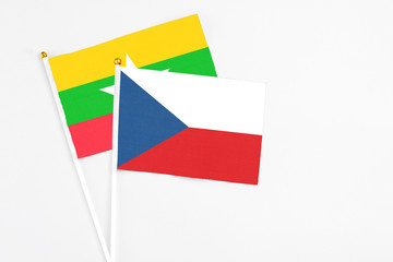 Czech Republic and Myanmar stick flags on white background. High quality fabric, miniature national flag. Peaceful global concept.White floor for copy space.