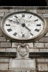 A beautiful old clock on a stone tower.  Clock tower, a symbol of the old town of Kotor.