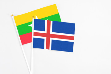 Iceland and Myanmar stick flags on white background. High quality fabric, miniature national flag. Peaceful global concept.White floor for copy space.