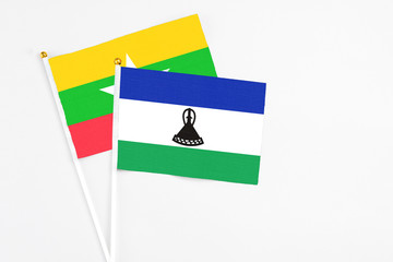 Lesotho and Myanmar stick flags on white background. High quality fabric, miniature national flag....