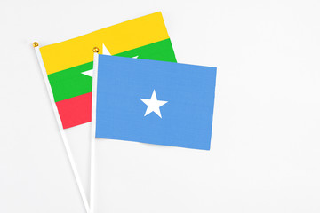 Somalia and Myanmar stick flags on white background. High quality fabric, miniature national flag. Peaceful global concept.White floor for copy space.