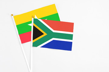South Africa and Myanmar stick flags on white background. High quality fabric, miniature national flag. Peaceful global concept.White floor for copy space.