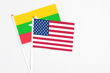 United States and Myanmar stick flags on white background. High quality fabric, miniature national flag. Peaceful global concept.White floor for copy space.