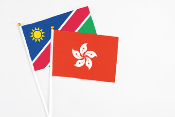 Hong Kong and Namibia stick flags on white background. High quality fabric, miniature national flag. Peaceful global concept.White floor for copy space.