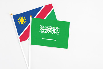 Saudi Arabia and Namibia stick flags on white background. High quality fabric, miniature national flag. Peaceful global concept.White floor for copy space.