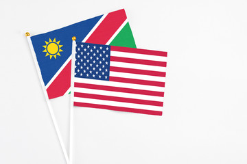 United States and Namibia stick flags on white background. High quality fabric, miniature national flag. Peaceful global concept.White floor for copy space.