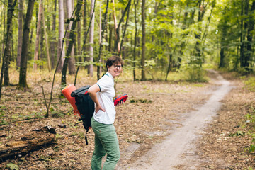 Woman tourist got back injury in forest and gets hurt. Health problem in the journey. Theme Insurance company. Pain in the spine with an active lifestyle. Traveling with backpacks with a sore back