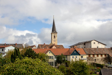 Fototapeta na wymiar View on a church tower of a small town in Austria