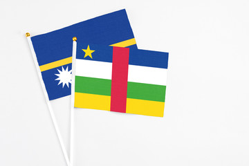 Central African Republic and Nauru stick flags on white background. High quality fabric, miniature national flag. Peaceful global concept.White floor for copy space.