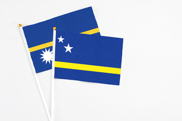 Curacao and Nauru stick flags on white background. High quality fabric, miniature national flag....
