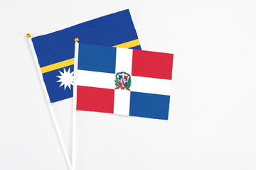 Dominican Republic and Nauru stick flags on white background. High quality fabric, miniature...