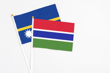 Gambia and Nauru stick flags on white background. High quality fabric, miniature national flag. Peaceful global concept.White floor for copy space.
