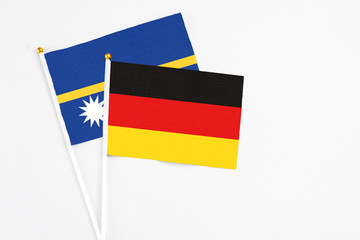 Germany and Nauru stick flags on white background. High quality fabric, miniature national flag....