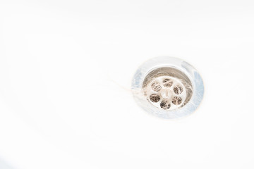 Naklejka premium long blond hair in the sink, wash your hair in the sink, clog the sewer concept