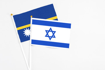 Israel and Nauru stick flags on white background. High quality fabric, miniature national flag....