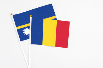 Romania and Nauru stick flags on white background. High quality fabric, miniature national flag....