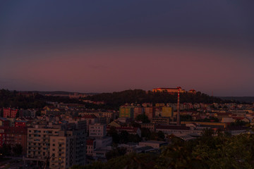 Fototapeta premium Castle Spilberk time-lapse captured in wide before sunset and castle turn on red light view in Brno city streets with building and surround area.
