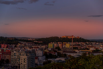 Castle Spilberk time-lapse captured in wide before sunset and castle turn on red light view in Brno city streets with building and surround area.