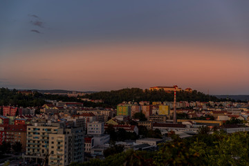 Castle Spilberk time-lapse captured in wide before sunset and castle turn on red light view in Brno city streets with building and surround area.