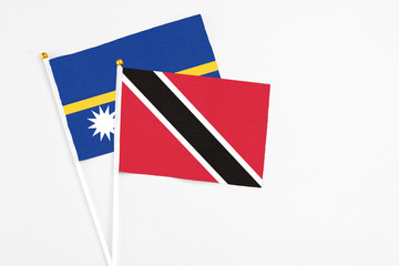 Trinidad And Tobago and Nauru stick flags on white background. High quality fabric, miniature...