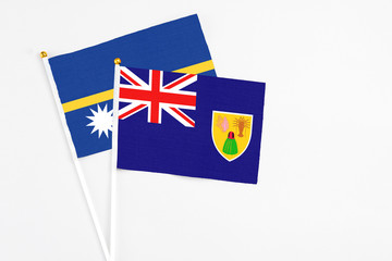Turks And Caicos Islands and Nauru stick flags on white background. High quality fabric, miniature...