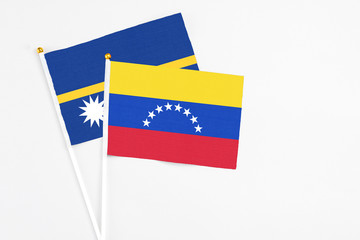Venezuela and Nauru stick flags on white background. High quality fabric, miniature national flag. Peaceful global concept.White floor for copy space.