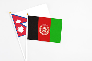 Afghanistan and Nepal stick flags on white background. High quality fabric, miniature national...