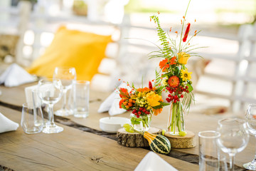 Beautiful autumn colored taable decoration for a special event. Fresh flower table decoration.